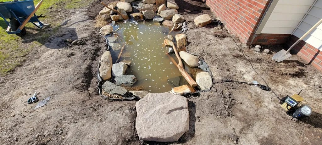 filling koi pond with water 